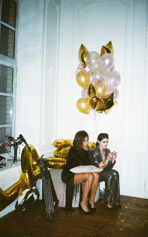 two women sitting at a party